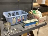 BOX + LAUNDRY BASKET OF DOILIES, TABLE CLOTHES, VACUUM SEALER, COOKBOOKS, SALT + PEPPER, OLD WRIST WATCHES, MISC