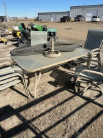 Large glass patio table with , six chairs and umbrella