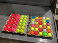 2 FLATS OF COLORED GOLF BALLS