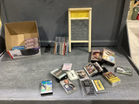 BOX W/CD&rsquo;S, CASSETTES, DVD&rsquo;S AND SMALL WASHBOARD