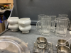 BOX W/ MISC HOUSEHOLD & DECOR ITEMS - TRAMONTINA SS CUPS/PLATES/SPOONS, GLASS STEINS, CERAMIC BOWLS W/ LIONS HEAD, POTTERY - 5