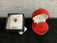HEART SHAPED NECKLACE W/ CREATED SAPHIRE AND STERLING SILVER CHAIN AND A PAIR OF SMALL BLUE CRYSTAL EARRINGS