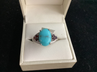 STERLING SILVER RING W/ TURQOISE STONE AND SOME PURPLE STONES ON THE SIDES