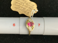RING IS SAID TO BE STERLING SILVER W/ GOLD PLATING AND PINK TOPAZ W/ (6) SMALL DIAMONDS