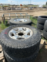 Four truck tires on aluminum rims