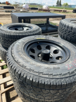 Set of four light truck tires on rims