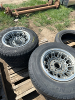 Four aluminum rims with tires