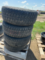 Four tires on black iron aluminum rims ( 2012 Yukon )