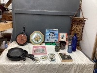 (3) SMALL BOXES OF HOUSEHOLD ITEMS - CAT BOOKS, DECOR, CAST FRYPAN CLOCK, NEEDLEPOINT PICTURE, "THE ROCK" FRY PANS