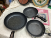 (3) SMALL BOXES OF HOUSEHOLD ITEMS - CAT BOOKS, DECOR, CAST FRYPAN CLOCK, NEEDLEPOINT PICTURE, "THE ROCK" FRY PANS - 5