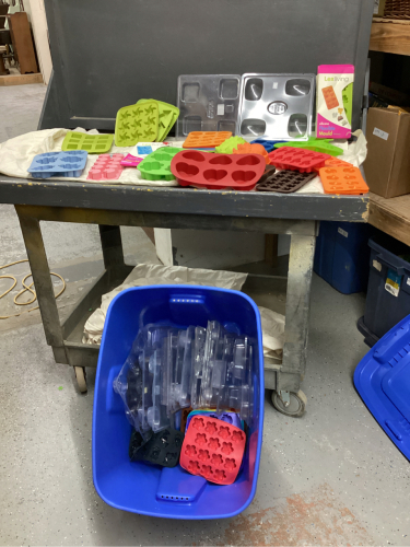 GOOD LIDDED TOTE FULL OF CHOCOLATE MOLDS