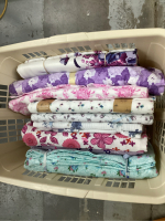 SMALL BOLTS OF FLANNEL AND COTTON/BLEND FABRICS IN LAUNDRY BASKET