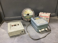 BOX W/ WIDE X TAPE, SAW HORSE BRACKETS, PARMAK FENCE CHARGER, BREAKER BOX