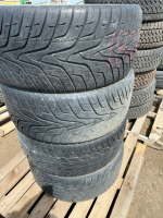 Stack of four tires on aluminum rims