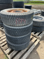 Stack of four winter tires on steel rims