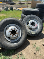 Three mismatched tires on steel rims