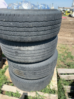 Stack of four Dodge truck tires