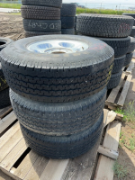 Stack of three Michelin tires on aluminum rims
