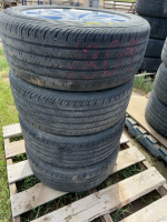 Set of four car tires on Ford rims