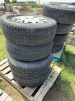 Stack of four car tires on Kia rims