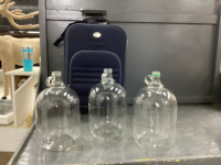 "JETSTREAM" CARRY ON SUITCASE AND (3) ONE GALLON JUGS