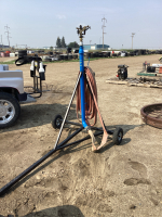 LARGE YARD SPRINKLER ON A 2-WHEEL STAND AND 2" LAY FLAT HOSE