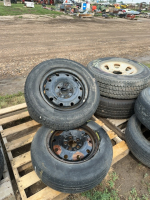 Four mismatched tires on rims