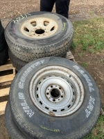 Four mismatched tires on rims