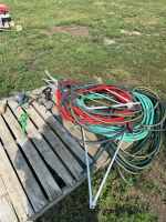 Pallet of sprinklers, hose and tripod