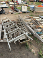 Two pallets of ladders, bed frame, and garden gate