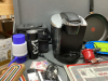 GOOD LIDDED TOTE W/ KITCHEN/HOUSEHOLD ITEMS - KEURIG, MISC PLASTIC DISHES, SEWING THREAD, CRIB BOARDS - 2