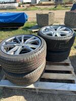 Stack of four Michelin tires on VW rims