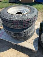 Stack of three Firestone tires on eight bolt trailer rims