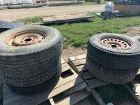 Five mismatched tires on rims