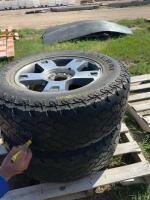 Two tires on aluminum rims