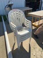 Four plastic stacking chairs