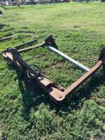 Three point hitch round bale un- roller