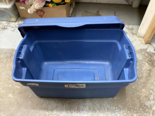 A BIG EMPTY RUBBERMAID TOTE