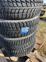 Stack of four winter tires on Buick rims