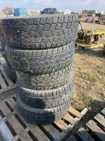 Stack of five mismatched tires