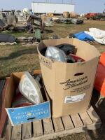 Two boxes of headlights and tail lights