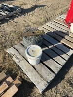 Pallet of new barbed, wire and full pail of staples
