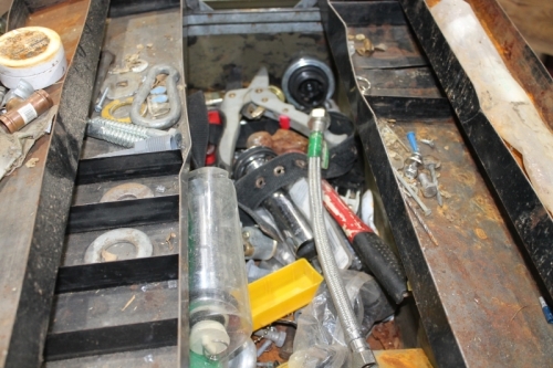 Rusted toolbox of miscellaneous plumbing