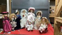 COLLECTION OF (8) PORCELAIN DOLLS AND A CAST/WOOD DOLL ROCKER