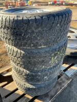 Stack of four Wrangler tires on six bolt rims
