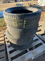 Stack of four Firestone tires