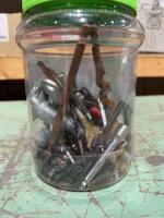 Plastic jar of miscellaneous drillbits, and drill tips