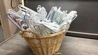 WICKER BASKET FULL OF PLASTIC HANGERS