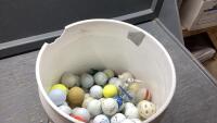 PARTIAL BUCKET OF GOLF BALLS