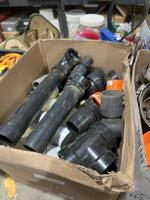 Two boxes of plumbing supplies and clamps
